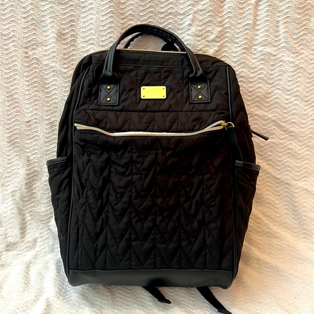 Black and gold Carter’s The Commuter diaper bag mini backpack